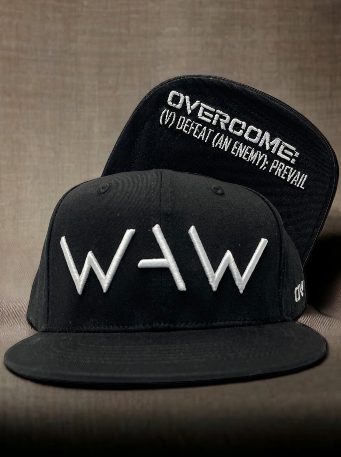 Black cap with WAW logo and Overcome message, WeAreWarriorsApparel.com