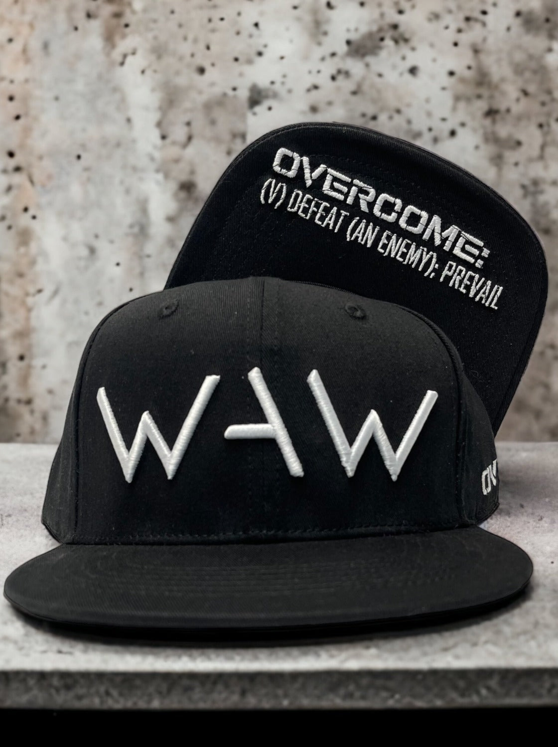Black cap with WAW logo and Overcome message, WeAreWarriorsApparel.com