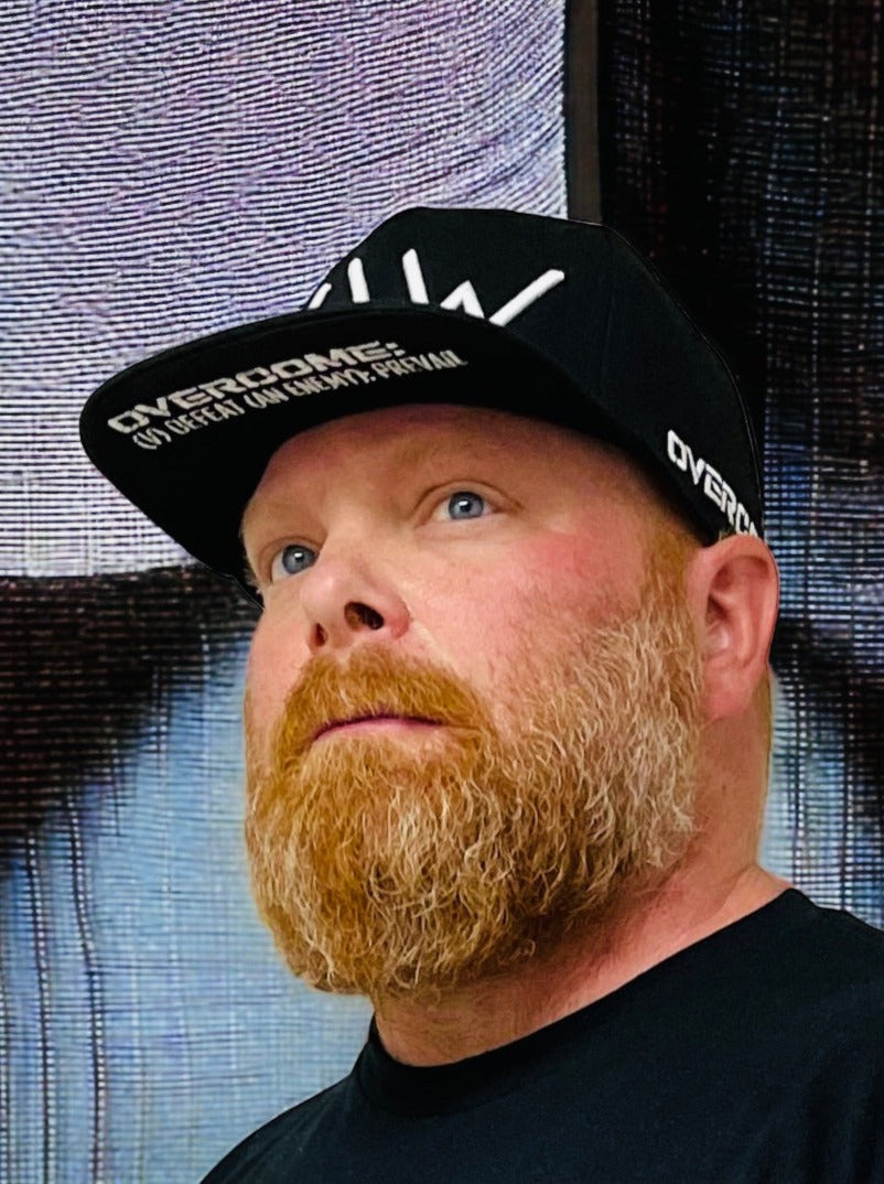 Black cap with WAW logo and Overcome message, WeAreWarriorsApparel.com